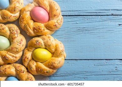 Easter Sweet Bread With Colored Eggs On Wooden Background