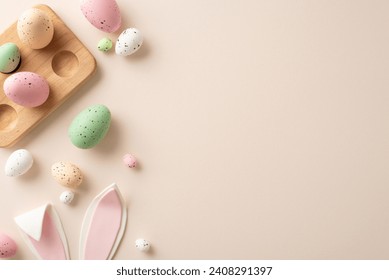 Easter sweetness captured from above. Traditional eggs in wooden holder, adorable bunny ears adorn a pastel beige background—perfect for your personalized text or promotional message