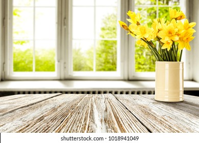 Easter Table Background Of Free Space For Your Product. Blurred Window Background. Eggs And Flowers Decoration. 