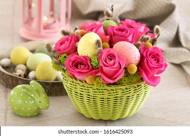 Easter table decoration with roses, moss and catkins. 