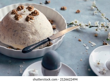 Easter Table With Easter Egg, Paschal Dish Dessert And Spring Flowers On A Blue Background. Delicious Food And Sweets With Tradition. Beautiful Composition In April. Close Up.