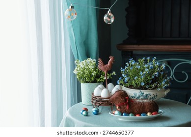 Easter table setting with easter cake in the shape of a lamb, spring flowers, eggs