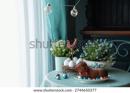 Easter table setting with easter cake in the shape of a lamb, spring flowers, eggs