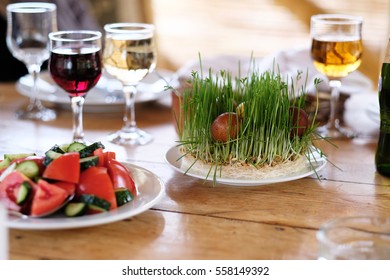 Easter Table Setting With Eggs, Wine And Decoration