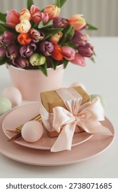 Easter Table Setting with Gift Box, Decorated Eggs and Tulips. Festive Spring Lifestyle