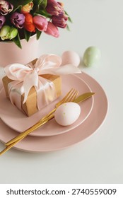 Easter Table Setting with Gift Box, Decorated Eggs and Tulips. Festive Spring Arrangement