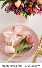 Easter Table Setting with Gift Box, Decorated Eggs and Tulips. Festive Spring Lifestyle