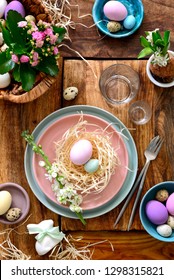 Easter table setting, holiday table home decor idea, flat lay composition with cutlery, Easter eggs and fresh flowers