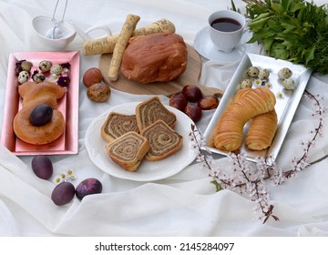 Easter Table With Walnut Potica, Smoked Ham, Horseradish, Poppy Seed Rolls In A Shape Of Easter Bunny, Wool Bread Rolls, And Easter Eggs. Bread Texture Of Easter Cake, Sliced Bread Roll With Walnuts.