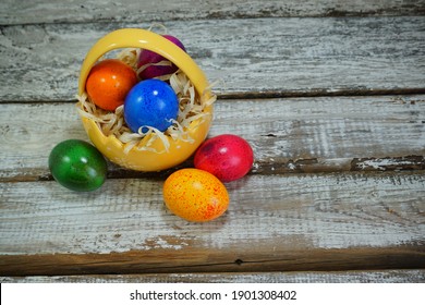 Easter tradition - Easter colorful eggs in a basket on a gray background - Easter composition. - Selective focus