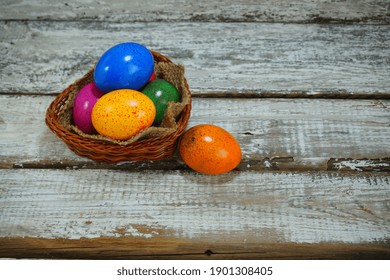 Easter tradition - Easter colorful eggs in a basket on a gray background - Easter composition. - Selective focus