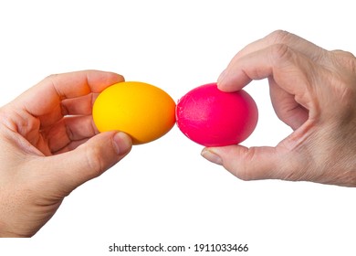 Easter tradition of cracking eggs, two hands hold eggs and try to break each other's egg, close up isolated white background - Shutterstock ID 1911033466