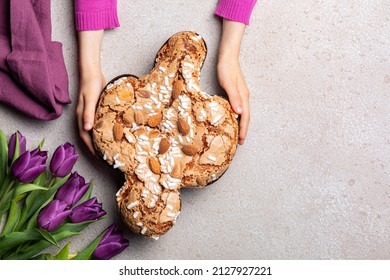 Easter tradition in Italy, Dove Cake topped with icing and almonds. Colomba di Pasqua.  Spring flowers. Top view.  - Shutterstock ID 2127927221