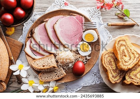 Easter traditional food with ham, eggs and bread. Holidays background. Easter table with all sorts of delicious delicatessen ready for an Easter meal.