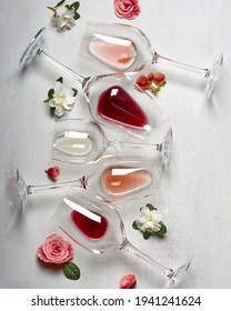 Easter wine glasses in flatlay with wite rose and red wine