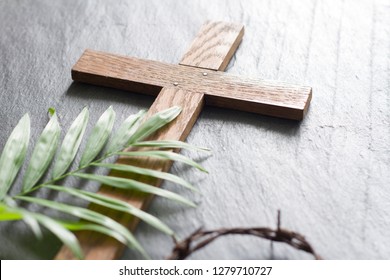 Easter wooden cross on black marble background religion abstract palm sunday concept