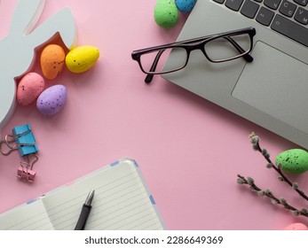 Easter work concept. Flat lay. Business work desk with devices and happy easter holiday multicolored eggs on pink background. Spring decoration workplace with gadgets. Work day on Easter holidays. - Powered by Shutterstock