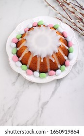 Easter Yeast Cake (Babka) On A White Plate On A Mardle Background. Top View. Traditional Easter Cake In Poland