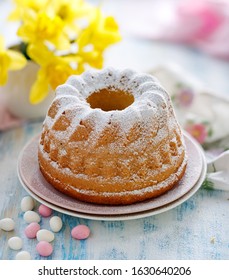 Easter Yeast Cake Sprinkled With Powdered Sugar On A Pink Plate. Traditional Easter Dessert In Poland