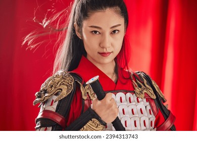 The Eastern beauty holds a long sword and is dressed in armor as the image of Mulan