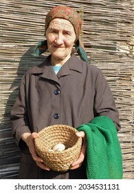 Eastern European Senior Farmer Woman Holding Eggs In Her Hands