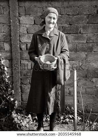 Eastern european senior farmer woman holding eggs in her hands