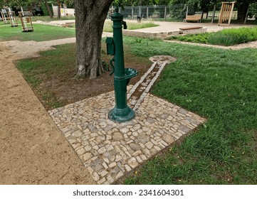 eastern oriental romantic style park with bench on ying yang mosaic tiles. drinking fountain with tap and sink for taking water healing mineral water - Powered by Shutterstock