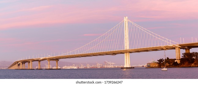 Eastern span of San-Francisco-Oakland Bay Bridge panoramic view at Twilight. Shot from Treasure Island, San Francisco, California, USA.