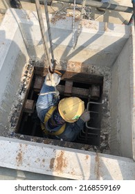 Eastern, Thailand - 17 June 2022: Worker Entry Manhole For Confined Space Work, With Safety Tripod