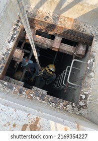 Eastern, Thailand - 20 June 2022: Worker Entry Manhole For Confined Space Work, With Safety Tripod.