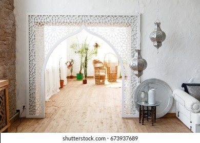 Eastern traditional interior. Arch with beautiful carving. White and gray room 