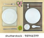 Eastern and western dining table place-settings and flowers