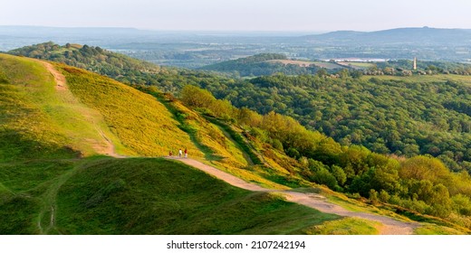Eastnor monument clearly seen on a summer morning amongst lush,green scenery, standing in the early golden sunlight,from the Malverns' natural beauty and heritage range of hills.