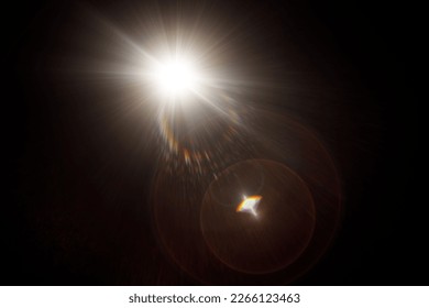 Easy to add lens flare effects for overlay designs or screen blending mode to make high-quality images. Abstract sun burst, digital flare, iridescent glare over black background. - Shutterstock ID 2266123463