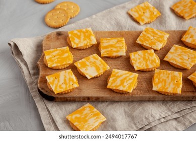 Easy Cheese and Crackers on a wooden board, side view.  - Powered by Shutterstock