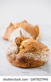 Easy homemade rustic bread. Traditional wheat bread on a white marble background. Artisan sourdough bread. - Shutterstock ID 1697827996