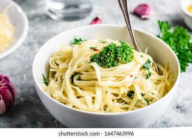 Easy lunch recipe. Linguine pasta with olive oil, garlic, fresh parsley and grated parmesan cheese. - Powered by Shutterstock