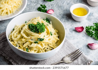 Easy lunch recipe. Linguine pasta with olive oil, garlic, fresh parsley and grated parmesan cheese. - Powered by Shutterstock