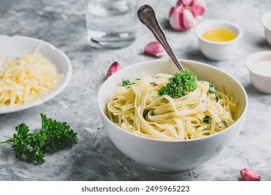 Easy lunch recipe. Linguine pasta with olive oil, garlic, fresh parsley and grated parmesan cheese. - Powered by Shutterstock