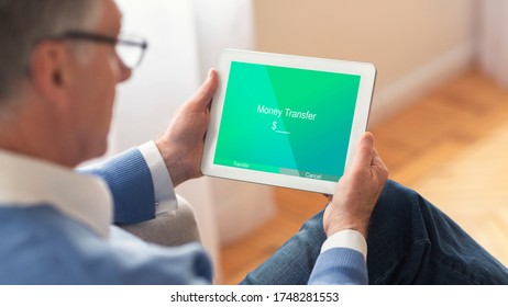 Easy Money Transfers. Unrecognizable Elderly Man Using Digital Tablet With Opened App For E-Banking At Home, Sending Finance To Kids, Selective Focus