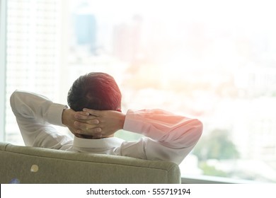 Easy relax business man lifestyle after work at hotel sitting hands behind head for happy businessmen people. Simplify Your Life Week. International happiness day. - Shutterstock ID 555719194