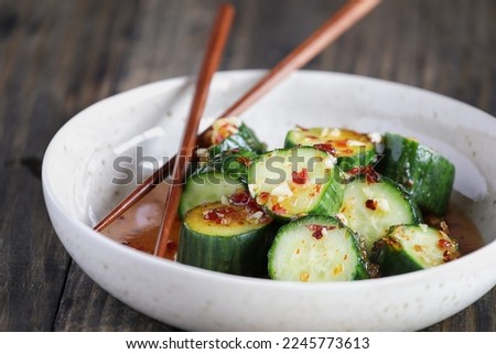 Easy Spicy Korean Cucumber Salad, Oi Muchim, made with garlic and hot peppers. Extreme selective focus with blurred foreground and background.