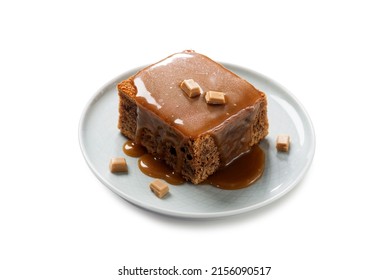 Easy Sticky Toffee Pudding is a deliciously gooey sponge cake drenched in warm toffee sauce that’s a favorite among the English. isolated on white background  