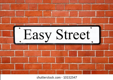 Easy Street Sign On A Brick Wall.