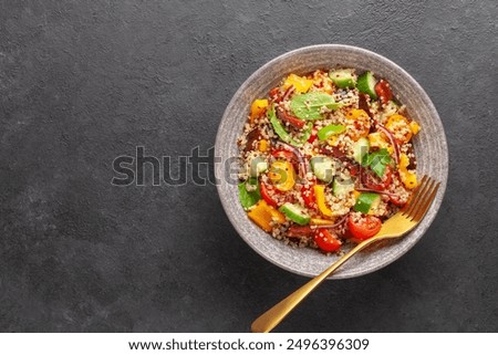 Similar – Image, Stock Photo A healthy bowl of fresh vegetables featuring sliced cucumber, cherry tomatoes, cauliflower florets, a lemon wedge, and arugula leaves on a wooden board with a side of mixed nuts