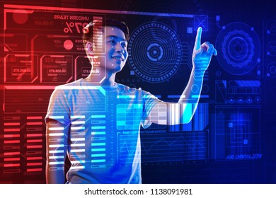 Easy work. Cheerful experienced programmer having a pleasant working day and smiling while touching the icon and working with a program