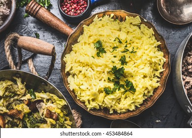 Easy Yellow Rice  flavored with Saffron in cooking pan on rustic background, top view