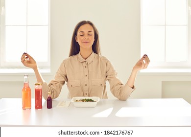 Eat and enjoy life. Happy relaxed young business woman meditating with eyes closed and reaching zen sitting at table with fresh healthy takeaway meal during lunch break at home or in sunlit office - Shutterstock ID 1842176767