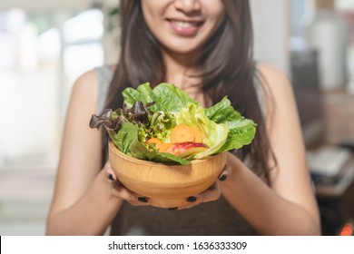 Eat High Fiber And Low Calories Foods For Good Health.Young Woman Eating Bowl Of Fresh Salad And Pure Water In The Morning.