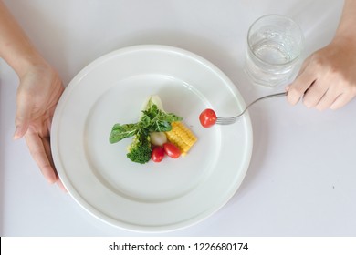 Eat Less And Eat Healthy. Person Eating Vegetable In Dinner During Control Calories On Dieting.